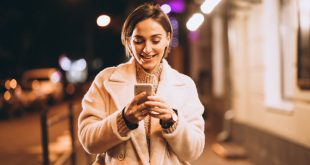 a girl standing and using mobile phone